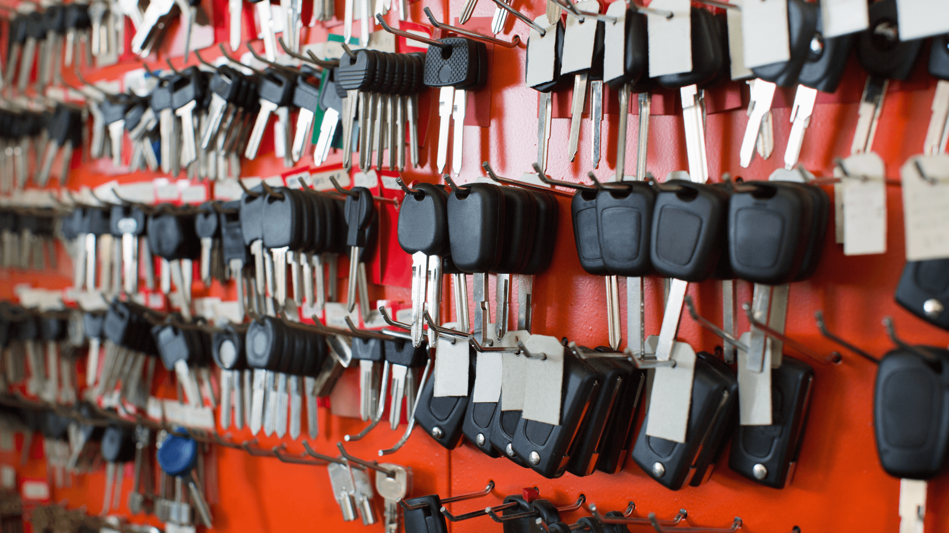 Many Types of Car Keys on a Red Wall