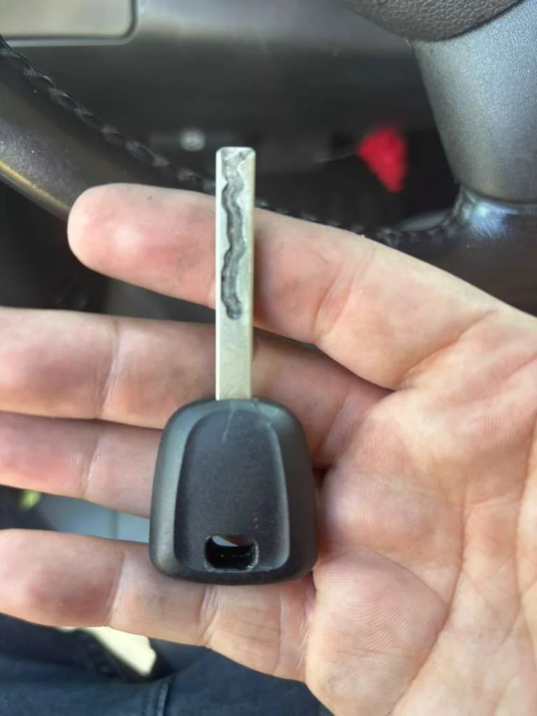 vehicle key and car prepared for replacement service, real company service photo 1